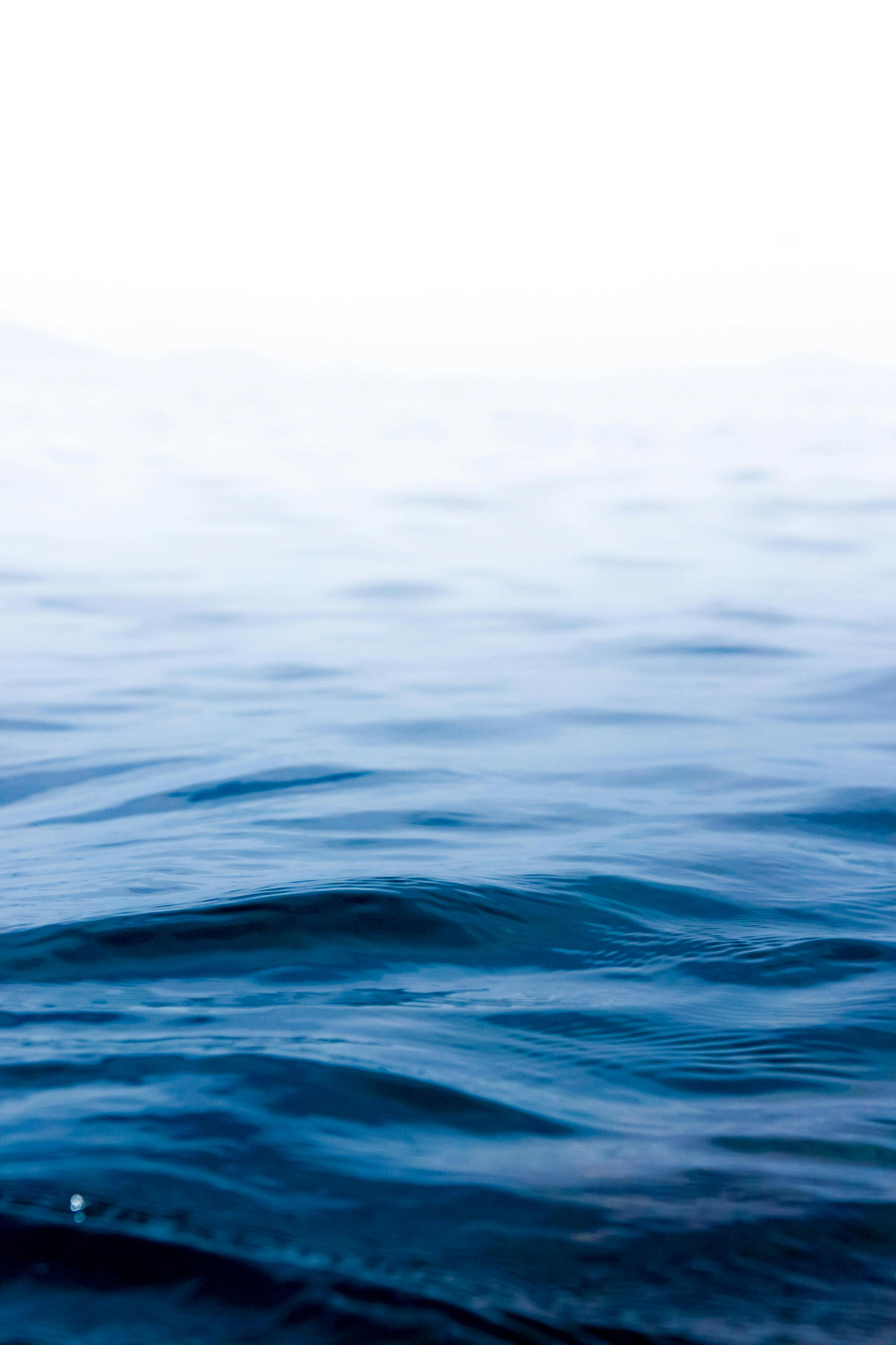 A close-up photo of the sea with ripples on its surface